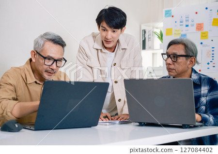 Asian Instructor Teaching Senior in Software Programming and Training Collaboration Asian Instructor Teaching Senior in Software Programming and Training Collaboration 127084402