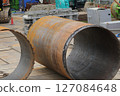 Large steel pipes at a building construction site 127084648