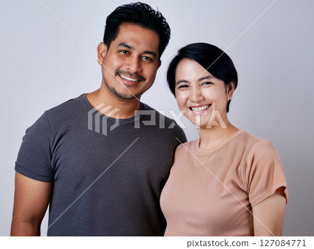 A couple of cuddling smiles 127084771
