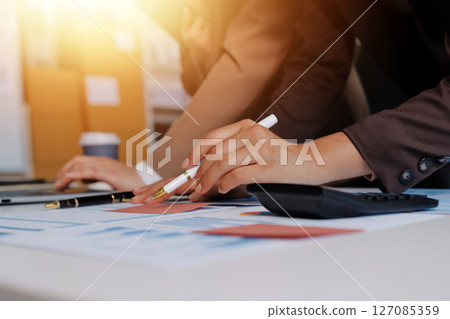 Accounting company provide finance and taxation planning for profitable cash flow, Auditor and accountant team working in office, analyze financial data and accounting record with calculator.Insight 127085359