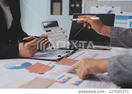 Accounting company provide finance and taxation planning for profitable cash flow, Auditor and accountant team working in office, analyze financial data and accounting record with calculator.Insight 127085371