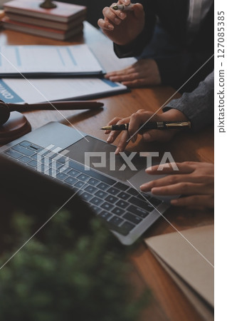 Judge gavel with Justice lawyers having team meeting at law firm background. Concepts of Law and Legal services. Judge gavel with Justice lawyers having team meeting at law firm background. Concepts of Law and Legal services. 127085385