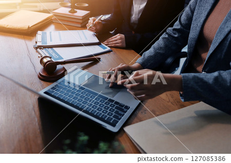 Judge gavel with Justice lawyers having team meeting at law firm background. Concepts of Law and Legal services. Judge gavel with Justice lawyers having team meeting at law firm background. Concepts of Law and Legal services. 127085386