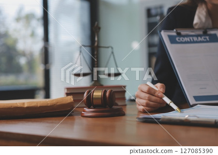 Judge gavel with Justice lawyers having team meeting at law firm background. Concepts of Law and Legal services. 127085390
