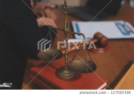 Judge gavel with Justice lawyers having team meeting at law firm background. Concepts of Law and Legal services. Judge gavel with Justice lawyers having team meeting at law firm background. Concepts of Law and Legal services. 127085396