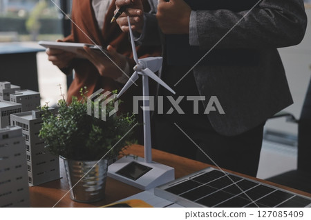 Discussion among businesspeople on the latest developments in solar cell panel technology and Solar Energy Environment city Concept. 127085409