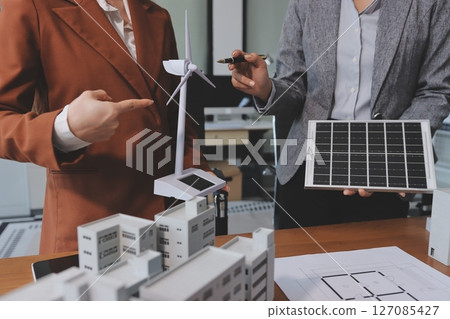 Discussion among businesspeople on the latest developments in solar cell panel technology and Solar Energy Environment city Concept. 127085427