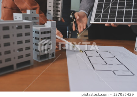 Discussion among businesspeople on the latest developments in solar cell panel technology and Solar Energy Environment city Concept. 127085429