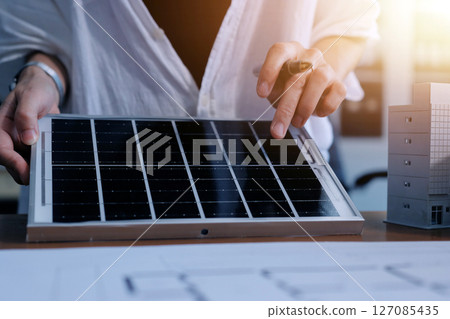 Discussion among businesspeople on the latest developments in solar cell panel technology and Solar Energy Environment city Concept. 127085435
