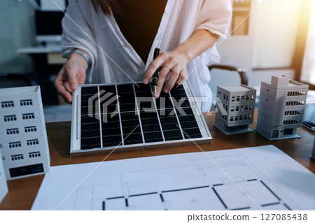 Discussion among businesspeople on the latest developments in solar cell panel technology and Solar Energy Environment city Concept. 127085438