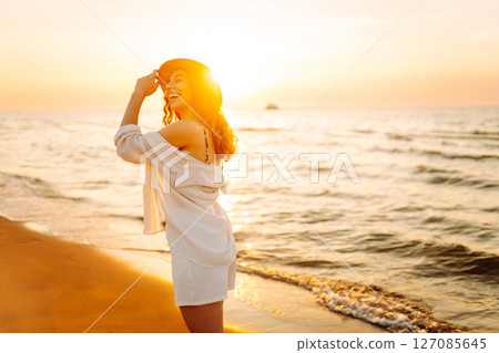 Happy woman on beach in summer style fashion trend outfit carefree and happy, feeling freedom. 127085645
