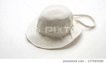 A white hat with a white strap is laying on a white background A white hat with a white strap is laying on a white background 127085880