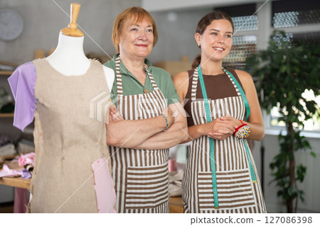 Elderly and young women seamstresses in workshop Elderly and young women seamstresses in workshop 127086398