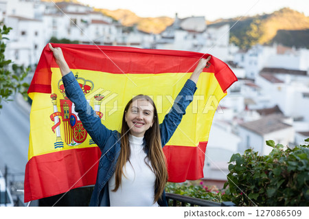 Hapy footbal fan woman waving the flag of Spain on street 127086509