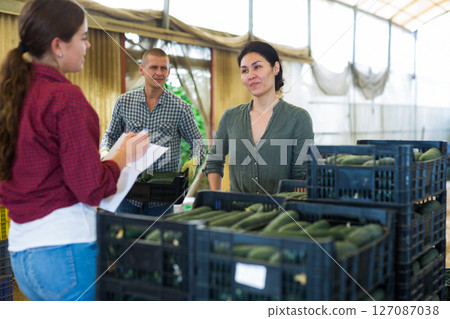 Woman, man and girl working in warehouse 127087038