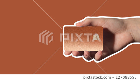 online payment. Hand holding bright plastic bankcard with chip in closeup for credit, debit, loan, 127088555