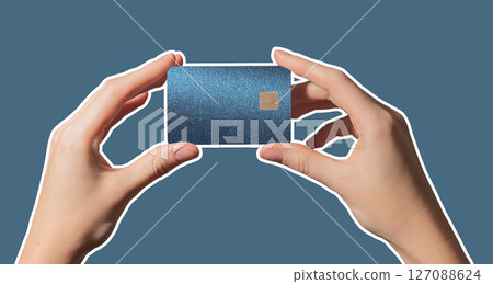 Colorful commerce concept. Hand holding bright plastic bankcard with chip in closeup for credit, 127088624