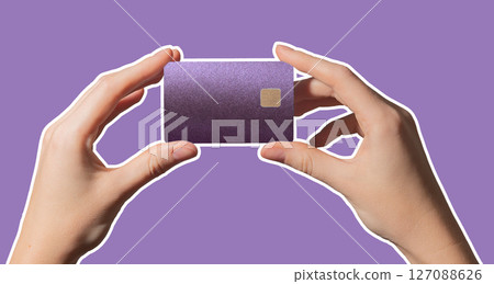 Bright cashless payment. Hand holding colorful plastic bankcard with chip in closeup for credit, 127088626