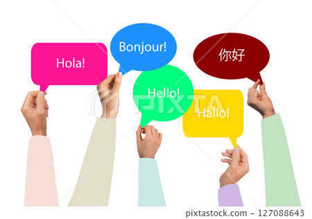 Hands group holding a multilingual speech bubble with Hello in various languages. Spanish, French, 127088643