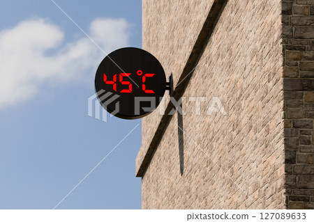 Street digital thermometer displaying a temperature of 45 degrees Celsius with blue sunny background. Street digital thermometer displaying a temperature of 45 degrees Celsius with blue sunny background. 127089633