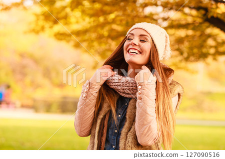 Smiling woman relaxing outdoor in autumnal park 127090516