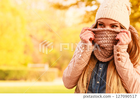 Girl hiding her face with scarf 127090517