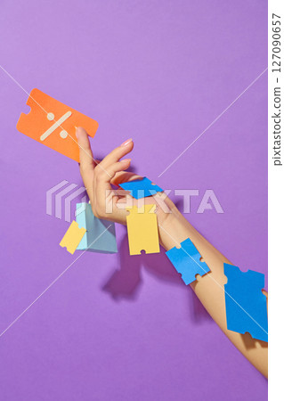 Hand holding a coupon, and vouchers stuck all over the arm on purple background. Illustrating an online storefront for digital marketing or shopping platform visuals. Hand holding a coupon, and vouchers stuck all over the arm on purple background. Illustrating an online storefront for digital marketing or shopping platform visuals. 127090657