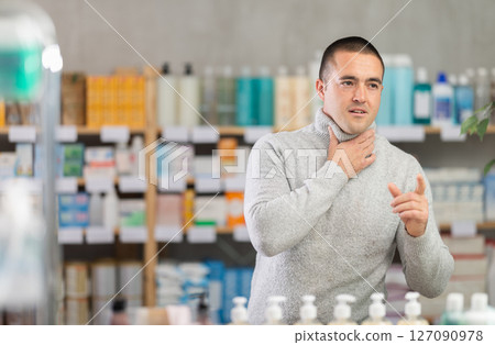 Man pharmacy client suffers from sore throat and cold Man pharmacy client suffers from sore throat and cold 127090978