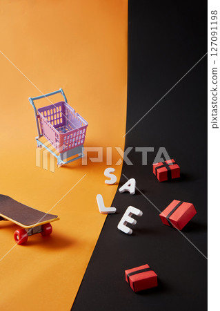 Colorful paper shopping carts and SALE text spread across an yellow and black background. Bright, modern imagery perfect for digital banners or sale alerts. 127091198