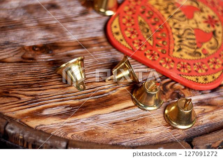 Wedding decoration in the Slavic style. Bells on the edge of a wooden barrel 127091272