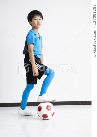 A boy with a soccer ball A boy with a soccer ball 127091285