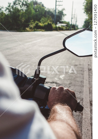 Attractive man riding a motorcycle. Sunny day 127091450