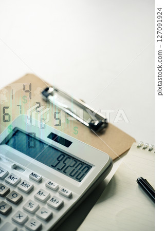 Calculator with financial figures and a digital overlay, representing accounting and financial analysis 127091924