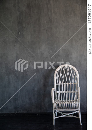 White armchair in the interior of a gray room White armchair in the interior of a gray room 127091947