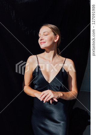 Beautiful fashion woman in black summer silk dress 127091986