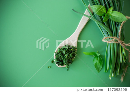 Top view of dried herbs and fresh green onions 127092296