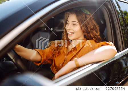Stylish woman driving car. Traveler is the driver. Automobile travel. Sharing car. Lifestyle concept Stylish woman driving car. Traveler is the driver. Automobile travel. Sharing car. Lifestyle concept 127092354