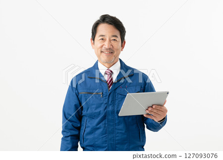 Middle-aged male engineer holding a tablet Middle-aged male engineer holding a tablet 127093076