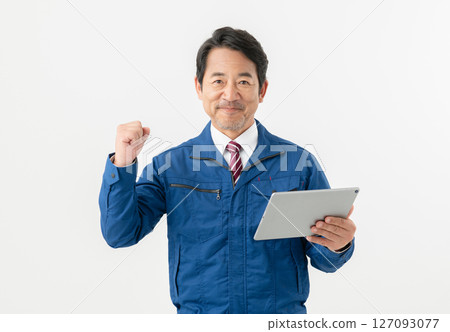 Middle-aged male engineer holding a tablet 127093077