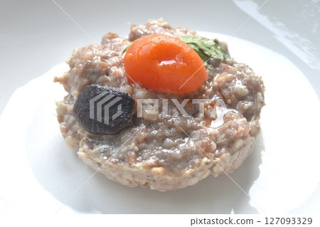 steamed chop pork topping salty egg yolk with black mushroom in gravy sauce on plate steamed chop pork topping salty egg yolk with black mushroom in gravy sauce on plate 127093329