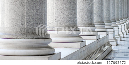 Row of white marble columns. Classical white marble columns standing in a row 127093372