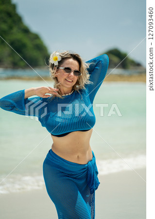 Girl with beautiful figure in blue beach dress on wild green tropical island Girl with beautiful figure in blue beach dress on wild green tropical island 127093460