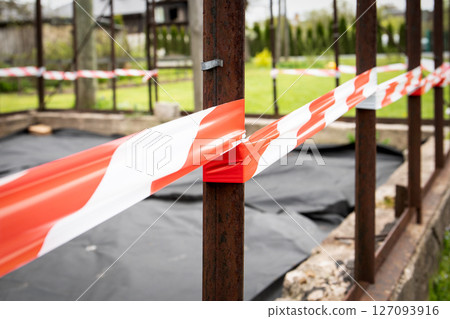 Construction Site with Red and White Caution Tape 127093916