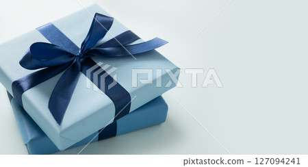 Banner with two blue gift boxes on pastel blue background. Greeting card, flyer or invitation. Close up. Copy space. Happy Fathers Day. Banner with two blue gift boxes on pastel blue background. Greeting card, flyer or invitation. Close up. Copy space. Happy Fathers Day. 127094241