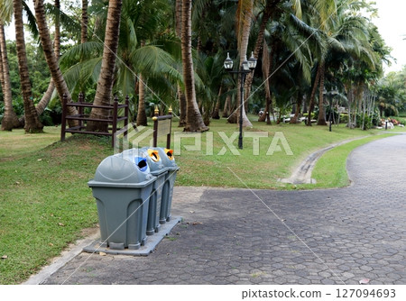 Row of plastic bins in nature public park. 127094693
