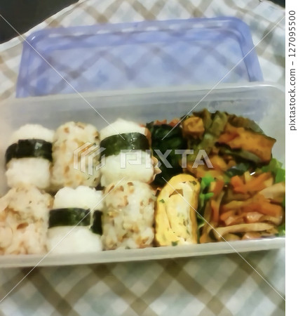 A bento box filled with rice balls A bento box filled with rice balls 127095500