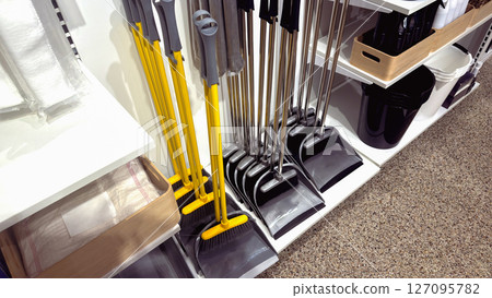 Dustpan and broom sets for cleaning in a supermarket Dustpan and broom sets for cleaning in a supermarket 127095782
