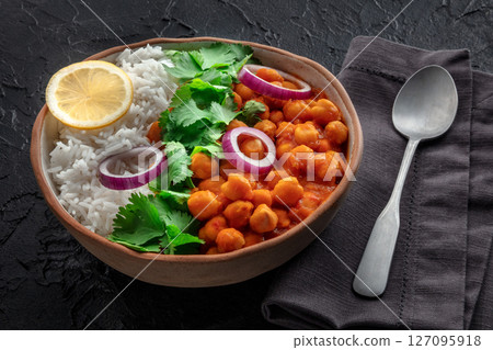 Chana masala, chickpea curry, traditional Indian dish, with fresh cilantro Chana masala, chickpea curry, traditional Indian dish, with fresh cilantro 127095918