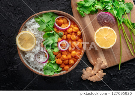 Chana masala, chickpea curry, traditional Indian dish, overhead flat lay shot Chana masala, chickpea curry, traditional Indian dish, overhead flat lay shot 127095920