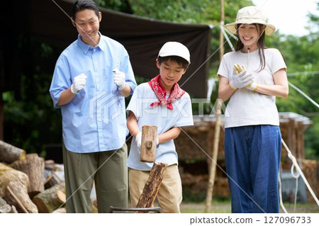 A boy enjoying chopping firewood 127096733